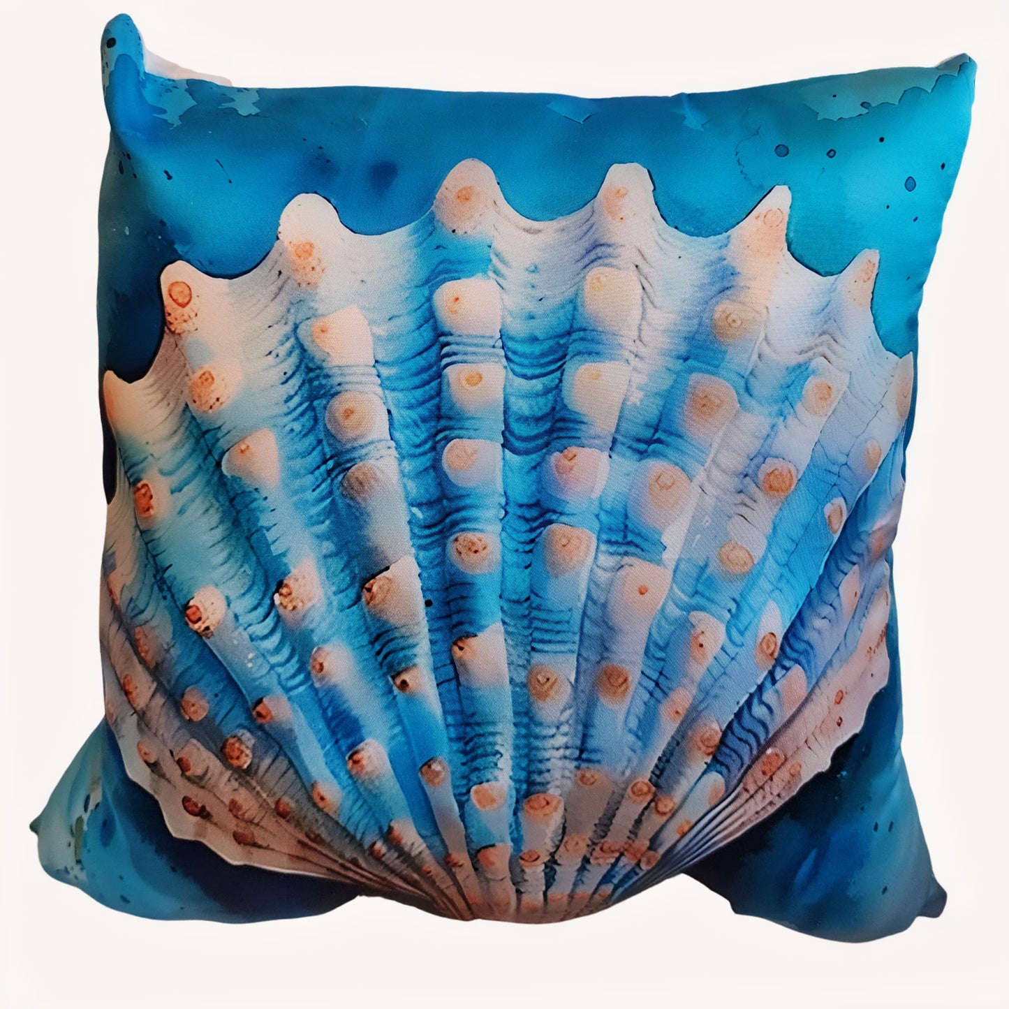 Decorative pillow with a blue and white shell pattern on a white background