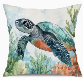 Decorative pillow with a turtle and coral design i an underwater background.