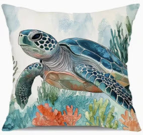 Decorative pillow with a turtle and coral design on an underwater scene.